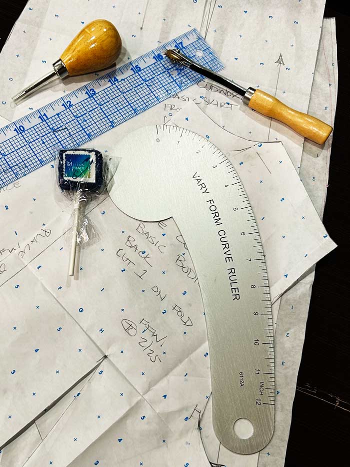 Clothing patterns with sewing tools on a table