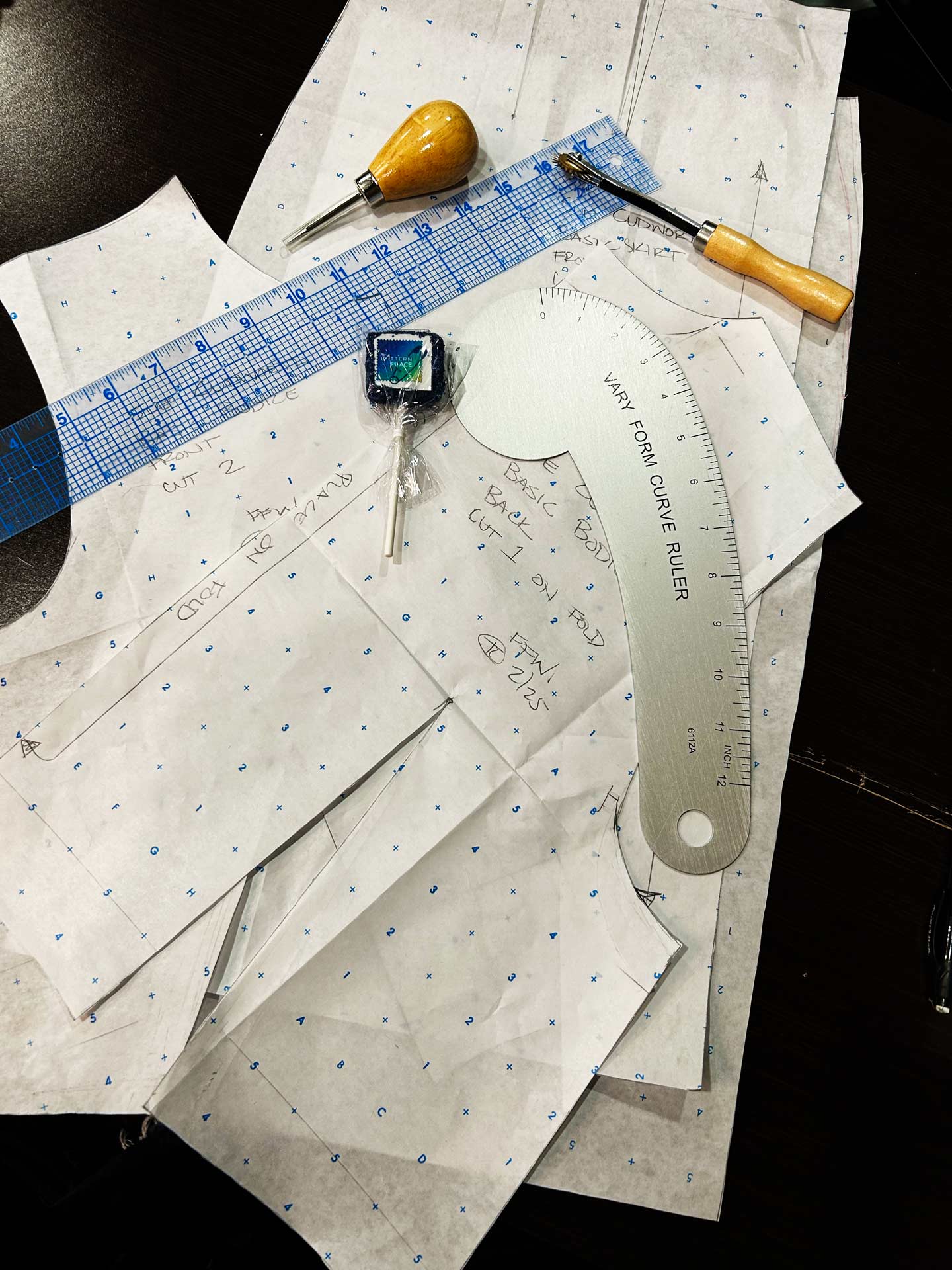 Clothing patterns with sewing tools on a table